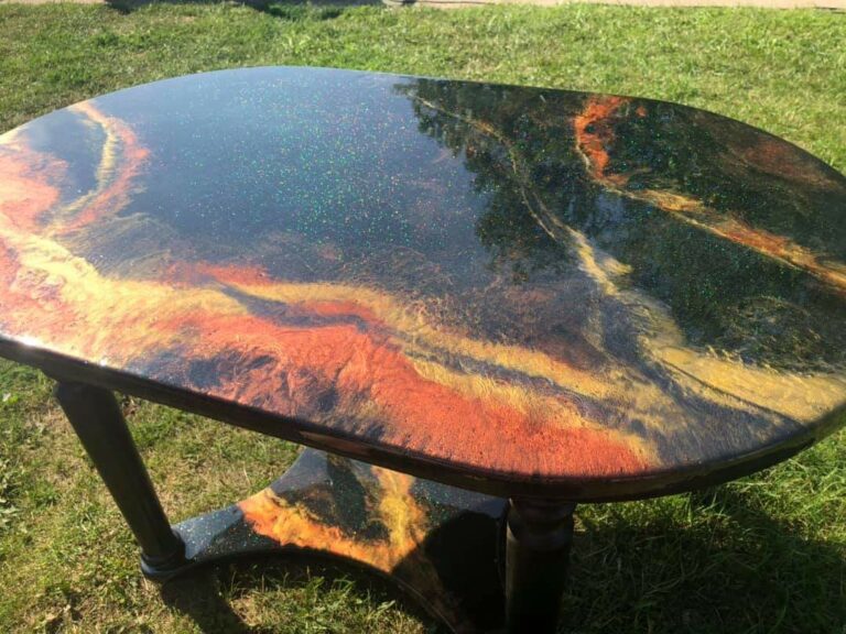An example of an epoxy resin table, coffee table in black, burnt orange and gold, by Home Statements