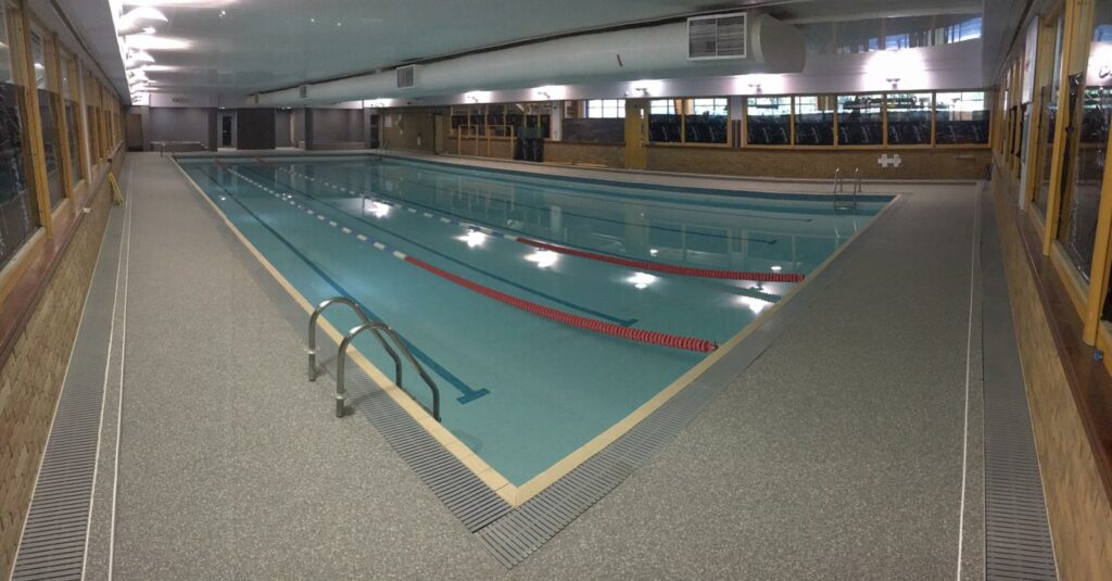 An example of a resin sand system swimming pool surround installed at an indoor leisure centre