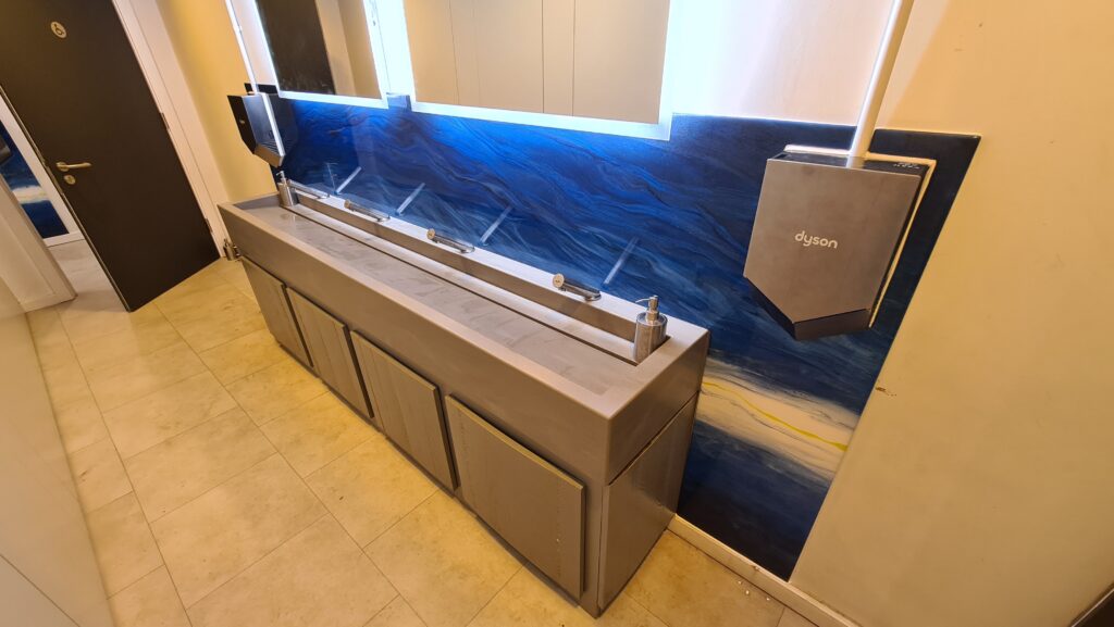 an example of an epoxy resin design splashback in a commercial bathroom by Home Statements Ltd